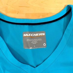 Bright blue Skechers scrub top